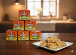Stacked boxes of Lovely Chikki Gazzak placed on table with peanut gazzak pieces served on a white plate.