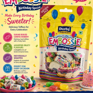 Colorful Derby Premia Embossie Birthday Special candy pouch featuring assorted individually wrapped fruity toffees, birthday-themed graphics, balloons, confetti, and a festive cake illustration on bright yellow packaging.